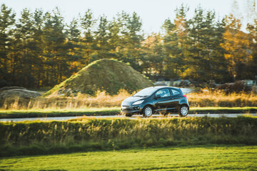 Fototapeta premium Electric compact car in natural environment