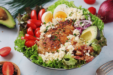A bowl with cobb salad, traditional American dish