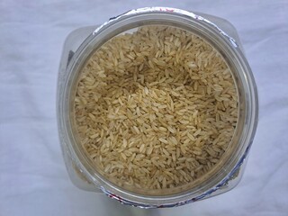 Brown rice in a plastic jar 