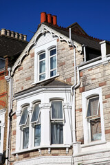 Victorian terraced town house in London England UK which has been decorated with modern stone  cladding with a clear blue sky, building and architecture stock photo image