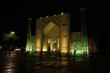 Fototapeta premium Illuminated Ulugbek Madrasasi of Registan Square at Night, Samarkand Uzbekistan