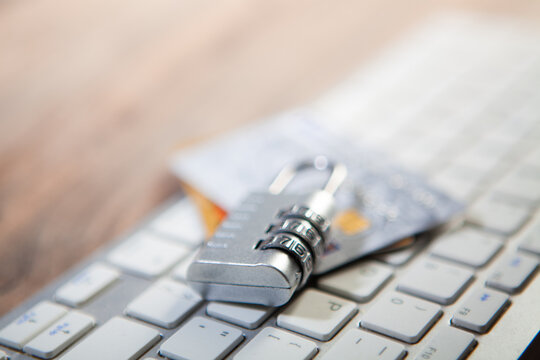 Credit card and padlock on a computer keyboard, business security concept