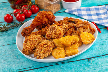 Golden crispy fried chicken mix - wings, drumsticks, nuggets and strips