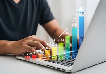 Man typing on a laptop with a rising bar graph overlay showing projected financial growth up to 2025