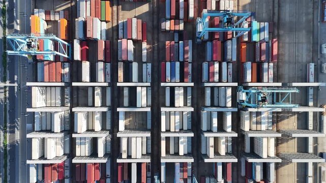 Aerial view of shipping container port terminal. Colourful pattern of containers in harbor. Maritime logistics global inport export trade transportation. 