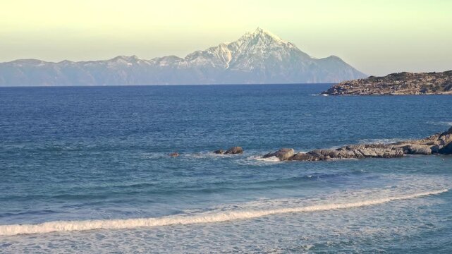 Beautiful coastal scenic Athos mountain horizon azure blue rippled water Greece