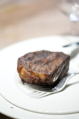 a piece of meat on a plate with a fork