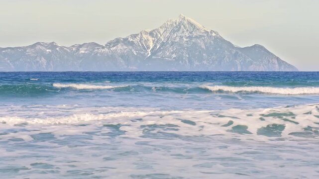 Beautiful scenery, holy Mount Athos dramatic skyline, blue water rolling waves
