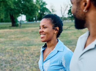 Obraz premium Happy active young black couple having fun walking running holding hands and bonding in park or nature outdoors