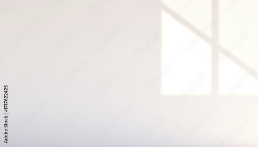 Poster simple white wall with natural light streaking through, creating a window shadow effect for backgrou