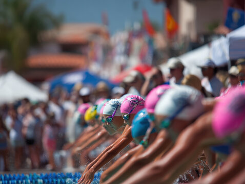 Young swimmers of diverse backgrounds prepare to dive in a competitive swim meet, under the watchful eyes of their coaches - Powered by Adobe