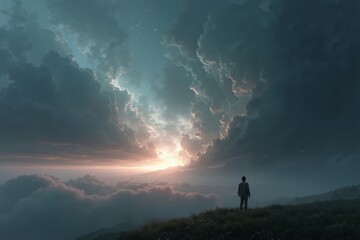 Obraz premium A man standing on top of a hill looking at the sunset