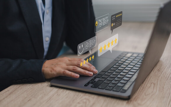 Businessman using laptop with customer review stars and feedback icons. Concept of online reputation management, digital marketing, customer satisfaction and rating system.