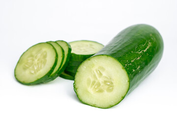 Fresh cucumber with sliced pieces isolated on clean white background © sumblistan