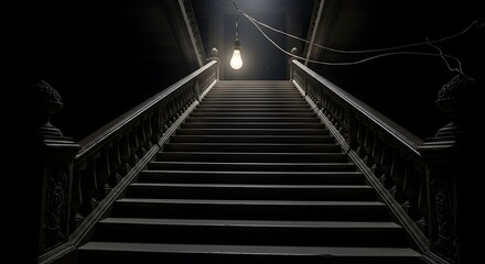 Fototapeta premium Intriguing staircase ascends into a dimly lit interior, illuminated by a single bulb, evoking a sense of mystery and suspense.