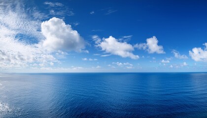 Fototapeta premium Panoramic Blue Sky With White Fluffy Clouds And Sea