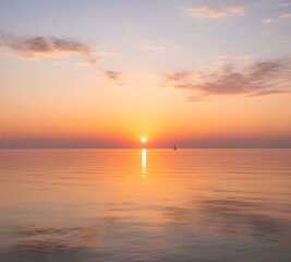 Sunset over calm sea with golden reflection