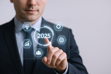 Businessman Touching 2025 Digital Screen Displaying Growth Icons, Symbolizing Future Corporate Goals and Visionary Strategic Planning