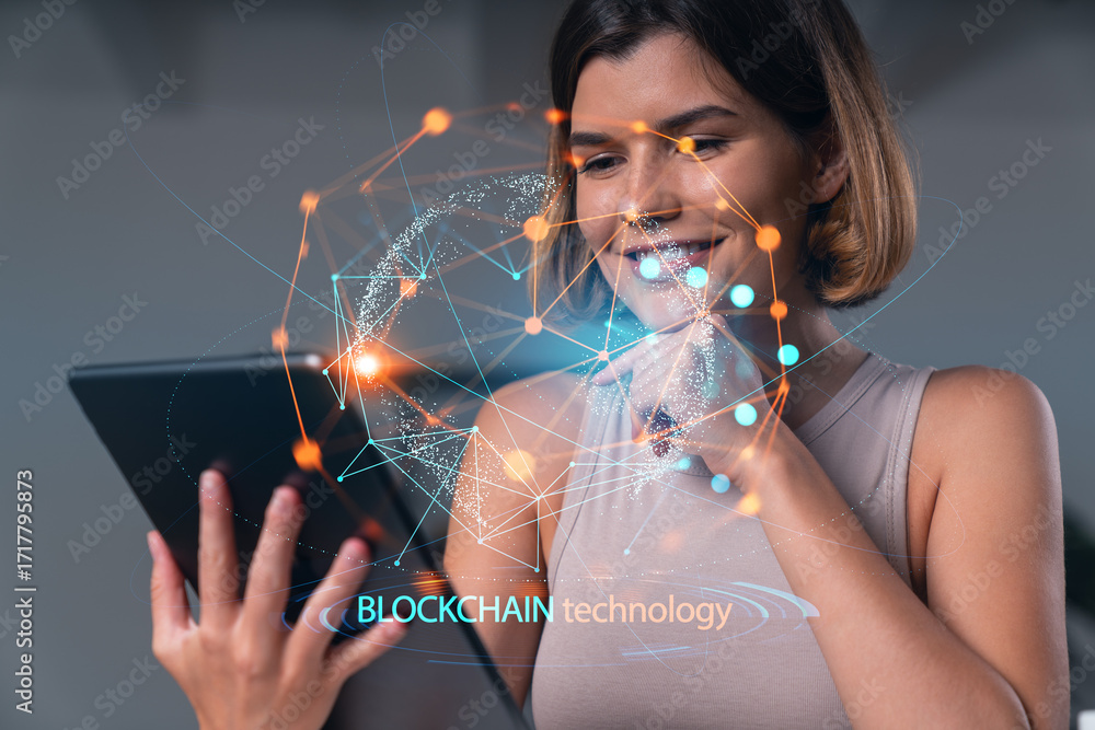 Poster woman using tablet with blockchain technology graphics overlayed digitally.