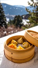 Fototapeta premium Steamed dumplings in a bamboo steamer on snow with a mountain view