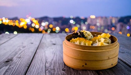 Steamed dumplings on a wooden table at sunset overlooking a city