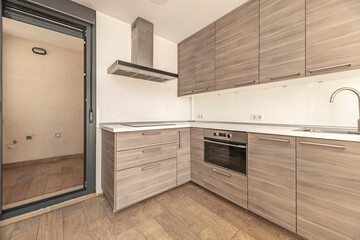Modern kitchen with natural granite island, bar area, and open shelves for displaying cookbooks