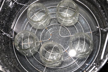 glass jars in water bath for Homemade Black Berry Jelly Canning with boiling Water bath for food preservation in glass jars