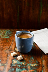 Cup of coffee on rustic wooden background. Soft focus. Copy space	