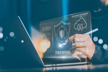 ฺฺBusiness professional interacts with a digital cyber defense interface showing security shield, cloud access, and data visualization. The UI represents next-gen cybersecurity environment.