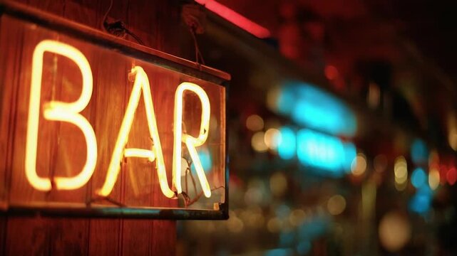 A neon BAR sign on a wooden wall inside a dimly lit bar with colorful blurred lights in the background.