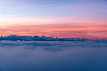Pastel Sunrise over Snowy Mountain Range – Baselland Panorama