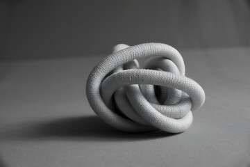 Fototapeta premium Abstract black and white close up of a complex knot made from a thick rope or cord