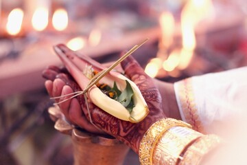 Bride and groom take part in traditional rituals during an Assamese wedding ceremony
