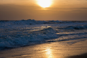 Sea and waves at sunset light