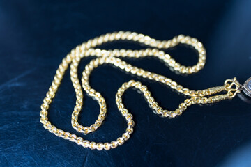 Elegant gold necklace on a black background