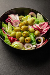 Salad olives, green leaf lettuce, vegetables natural product tasty snack fresh delicious gourmet food background on the table rustic top view copy space keto and paleo diet vegan and vegan food