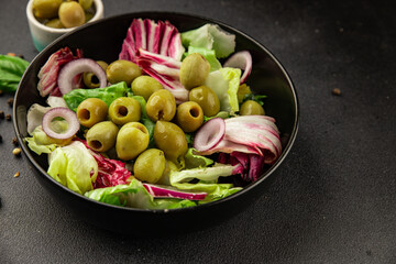 Salad olives, green leaf lettuce, vegetables natural product tasty snack fresh delicious gourmet food background on the table rustic top view copy space keto and paleo diet vegan and vegan food