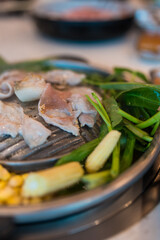 Thai style pork pan BBQ grill with vegetable soup called MooKaTa. Selective focus