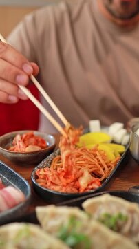 Close-up of kimchi, banchan, and other Korean appetizers in a restaurant. Fermented food, traditional Asian meals.