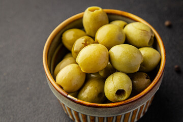 Green olives pickled seedless natural product tasty snack fresh delicious gourmet food background on the table rustic top view copy space