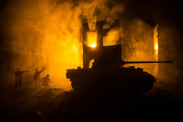 War Concept. Military silhouettes fighting scene on war fog sky background, World War Soldiers Silhouette Below Cloudy Skyline At night. Battle in ruined city.