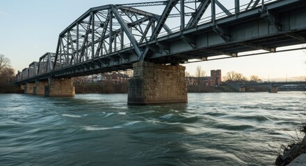 Fototapeta premium Steel Truss Bridge over River at Sunset