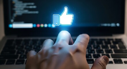 Hand reaching for a glowing thumbs up icon on a laptop screen with code in the background view