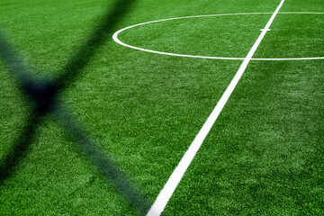Soccer field with green grass and white line, sport background.