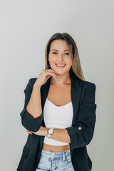 woman with long hair stands confidently against a clean white background