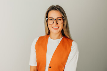 woman with long hair and glasses stands on white background