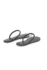 A pair of simple gray flip flops on a black background