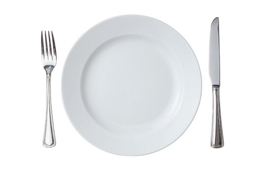 Elegant white plate silverware arrangement ready for a fine dining experience on black background