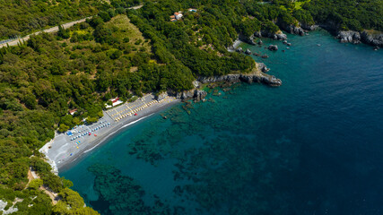 Naklejka premium Aerial view of Macarro Beach, located in Maratea, in the province of Potenza, Basilicata, Italy. It's a popular seaside resort overlooking the Mediterranean Sea, with its distinctive black sand beach.