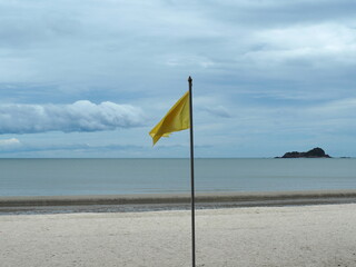 A yellow flag placed on beach indicates 